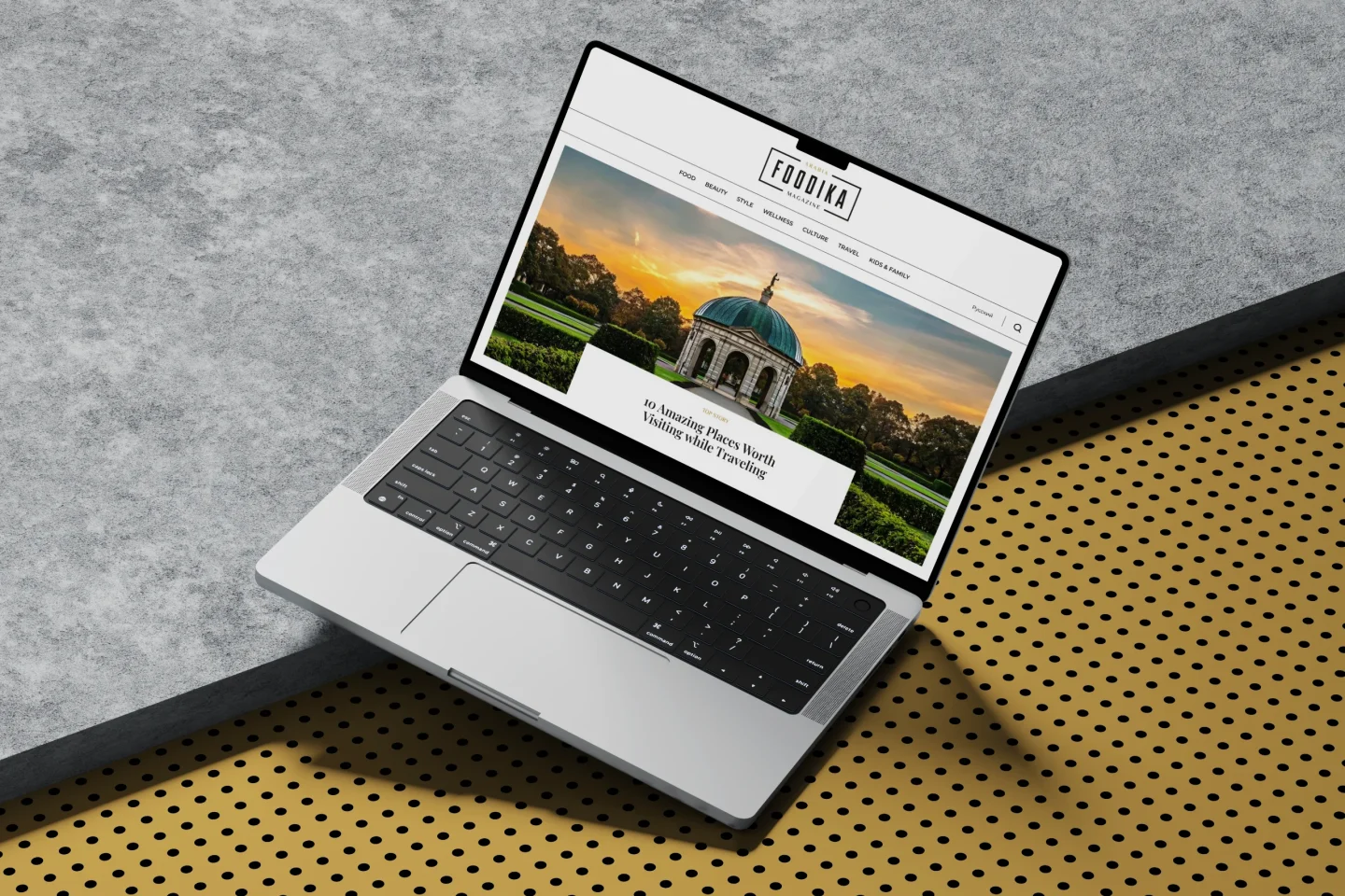 Digital magazine website hero section featured on a laptop display.