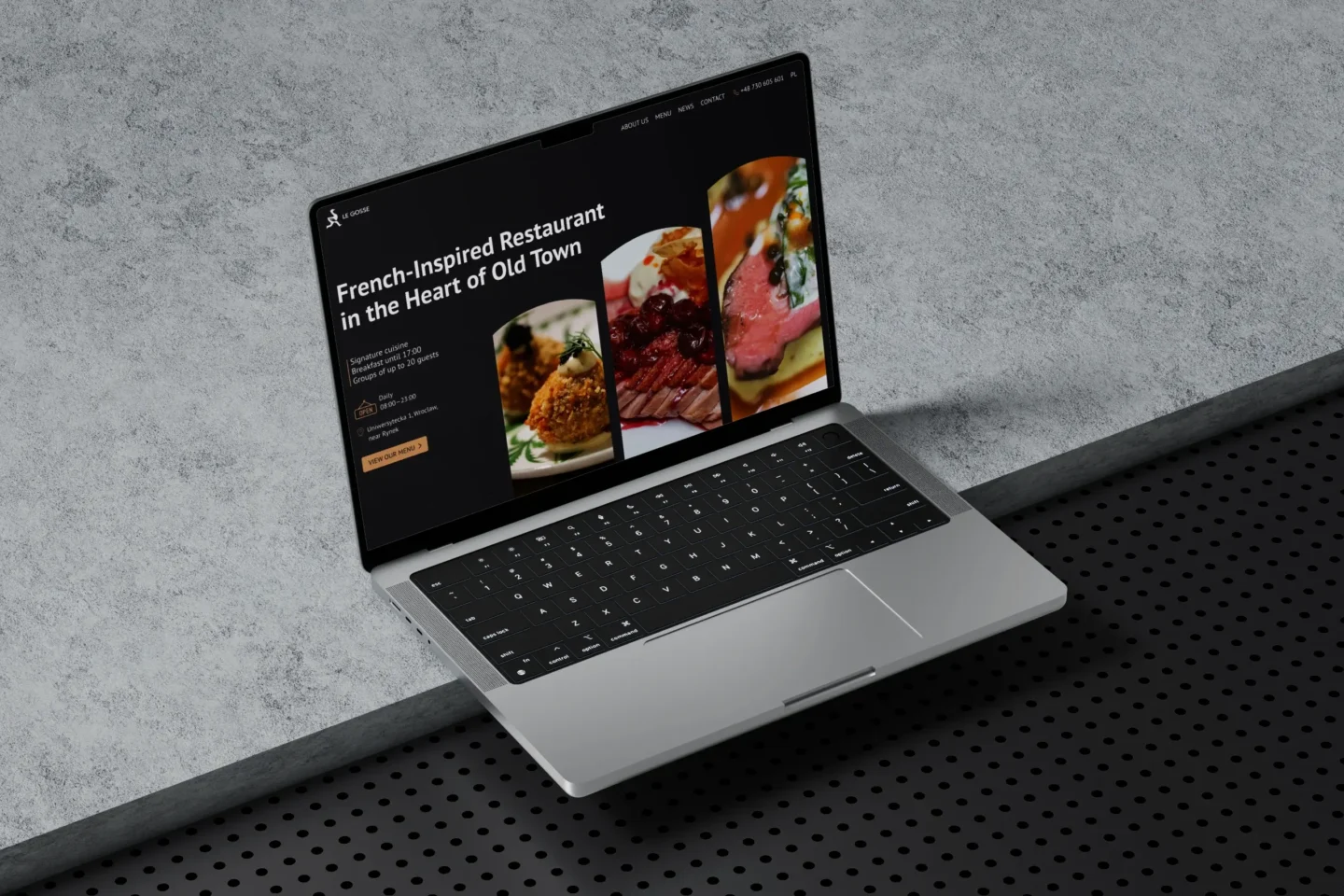 French restaurant website hero section featured on a laptop display.